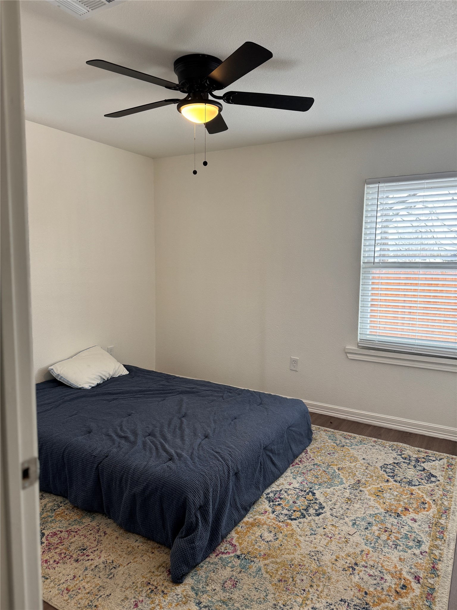 5607 Collins Road Houston, TX 77016 - Photo 8 of 9 a bedroom with a bed and a window