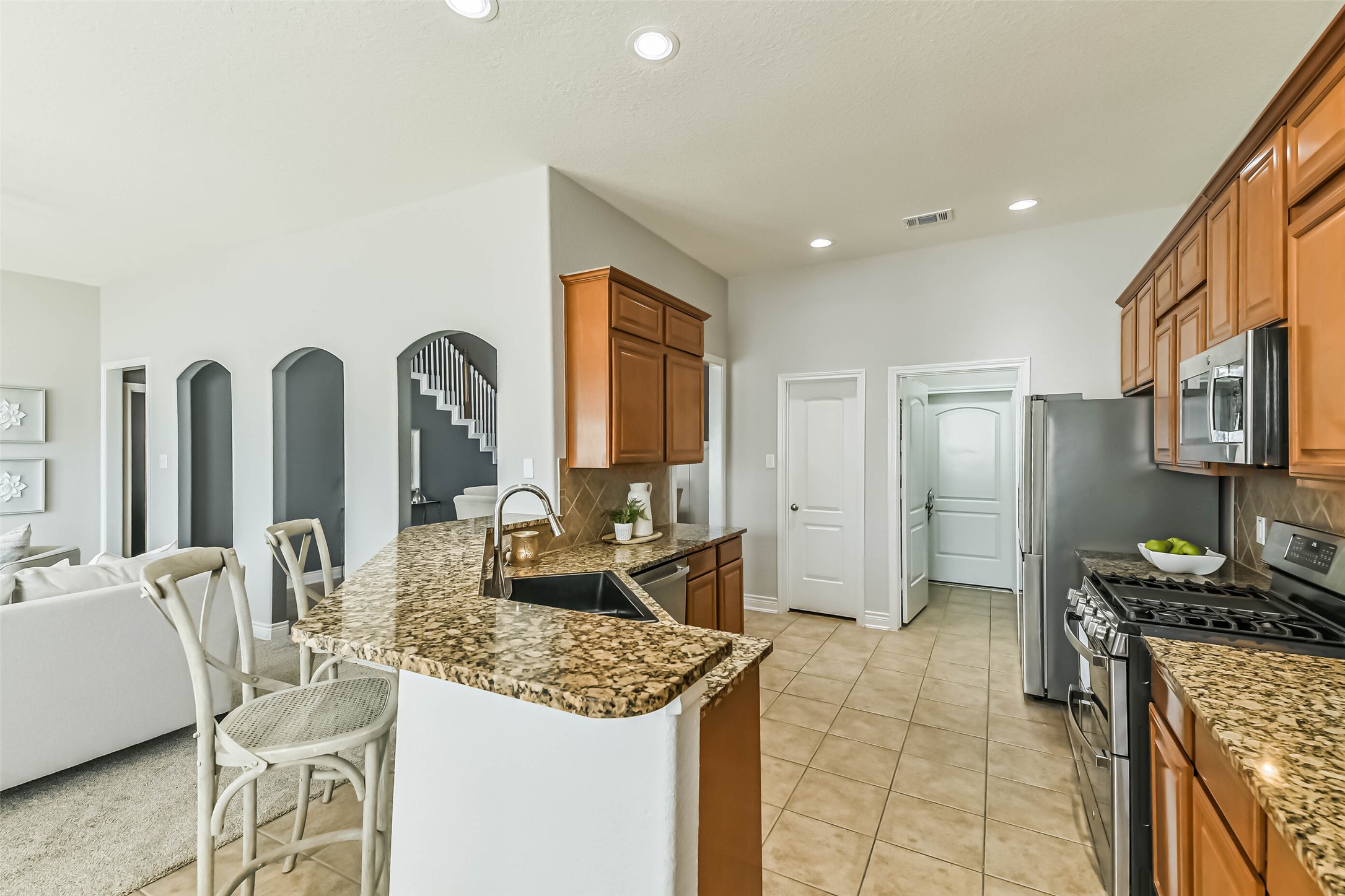 19022 Greenleaf Ridge Court Cypress, TX 77429 - Photo 17 of 47 a open kitchen with stainless steel appliances granite countertop a stove refrigerator and cabinets
