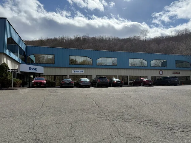 a view of building with cars parked
