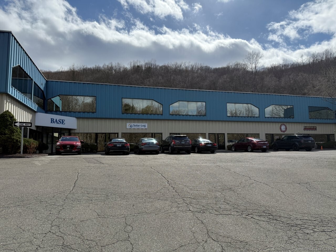 a view of building with cars parked