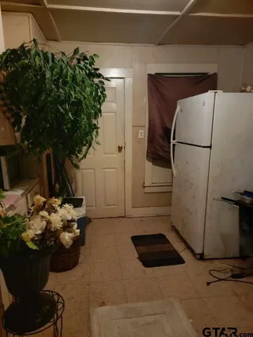 a hallway with a view of living room