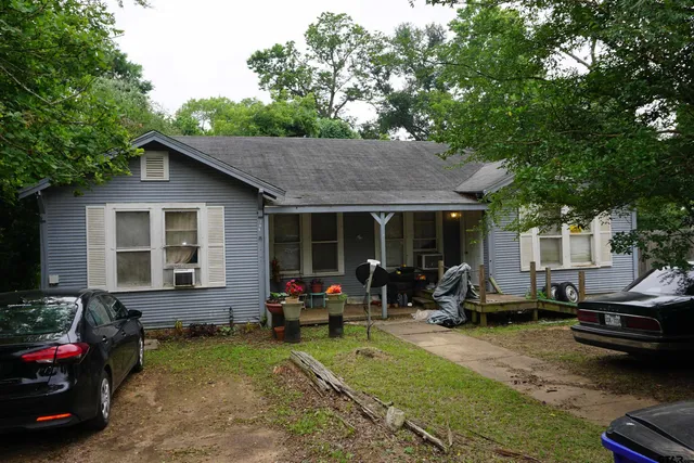 a view of the house with backyard space and sitting area