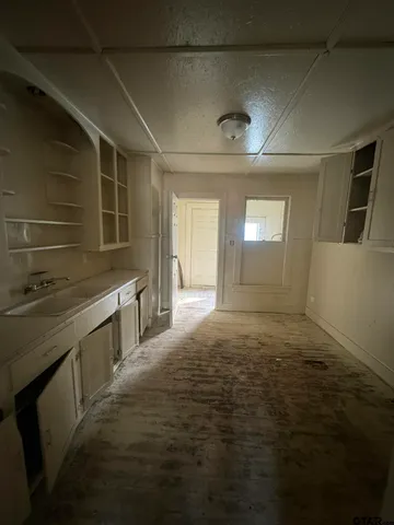 a kitchen with stainless steel appliances a sink and cabinets