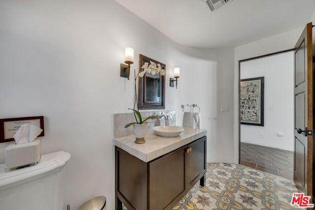 a bathroom with a tub sink and mirror