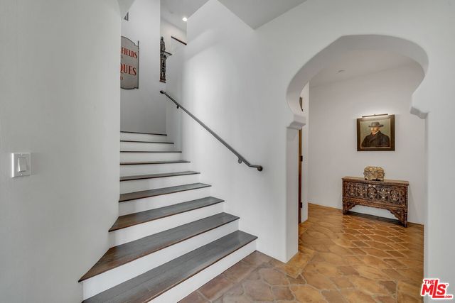 a living room with furniture kitchen view and a window
