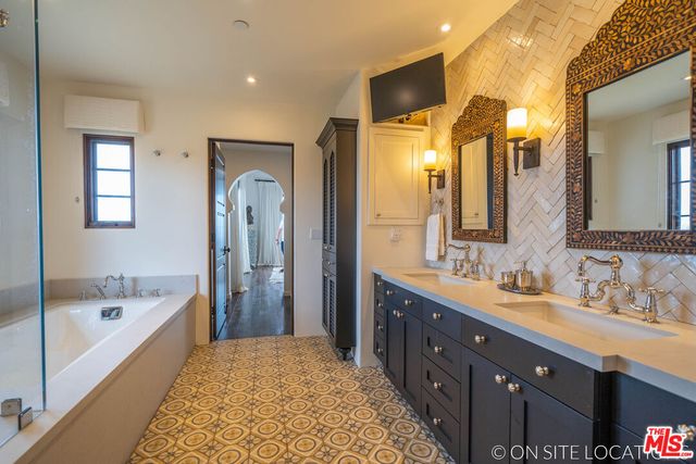 a bathroom with a double vanity sink and mirror