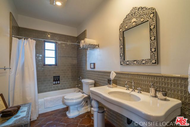 a view of a chairs and table in a patio with swimming pool