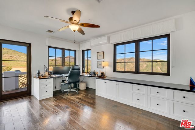 a front view of a house with swimming pool and outdoor seating