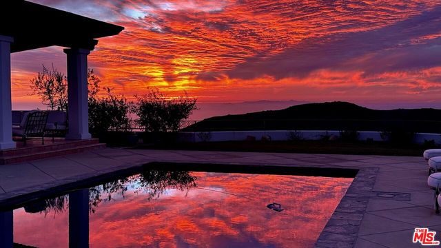 a front view of a house with parking space