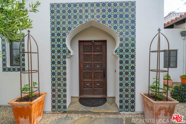 a view of a dining room and livingroom with furniture a chandelier and wooden floor