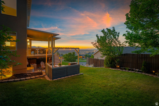 14883 Tooele Lane Draper, UT 84020 - Photo 48 of 49 Multi-level deck with a covered upper patio, glass panel railings, and a built-in pergola feature