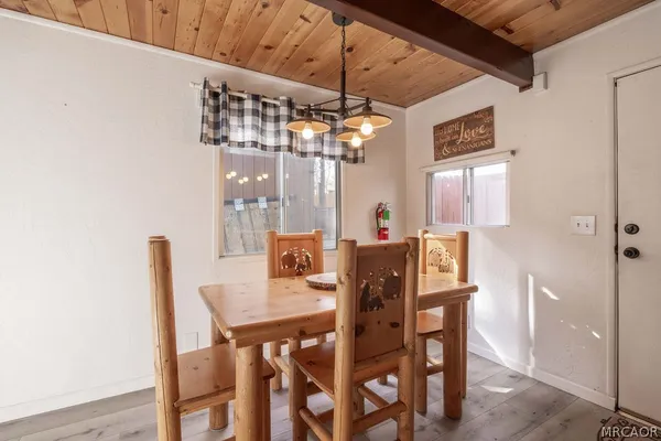 a view of a dining room with furniture and window