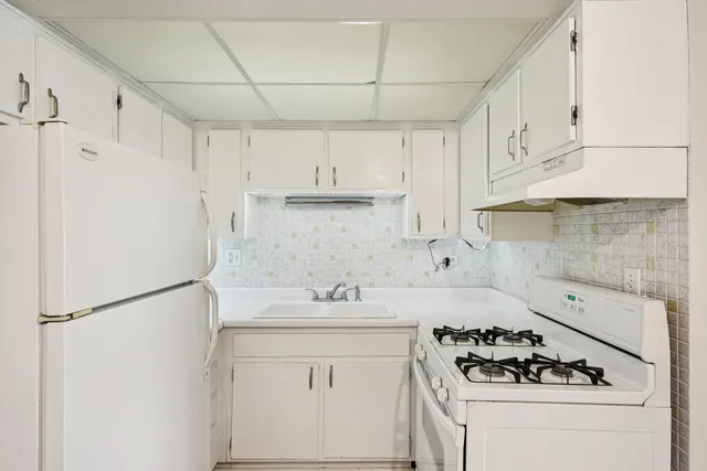 a kitchen with stainless steel appliances a refrigerator sink and cabinets