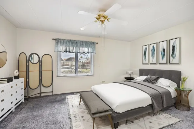 a bedroom with bed and window