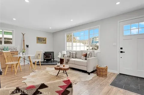 a living room with a couch a rug and a window