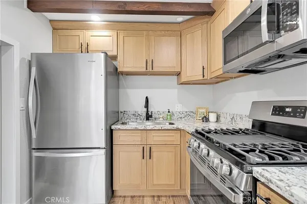 a bathroom with a granite countertop sink a toilet and a mirror