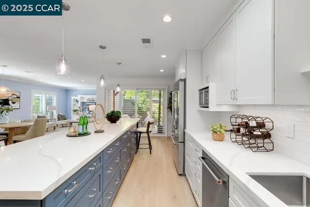 a kitchen with counter top space cabinets and stainless steel appliances