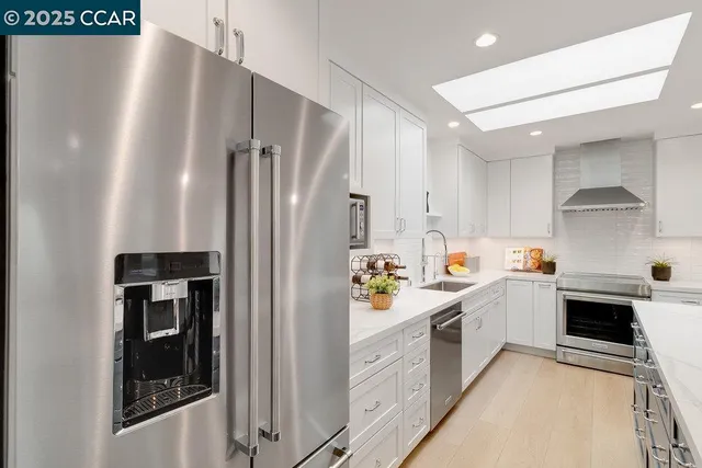 a kitchen with refrigerator and cabinets