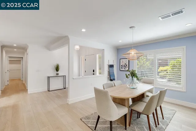 a view of a dining room with furniture and window