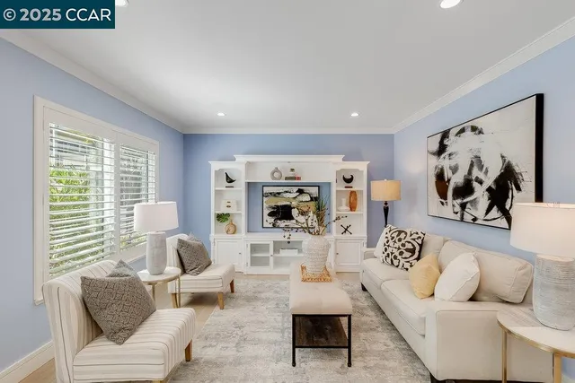 a living room with furniture and a large mirror with wooden floor