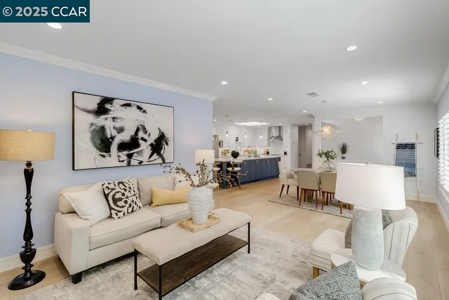 a living room with furniture and kitchen view