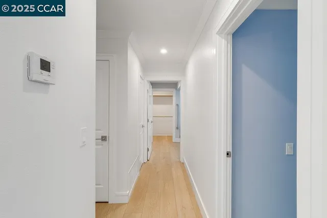 a view of a hallway with wooden floor