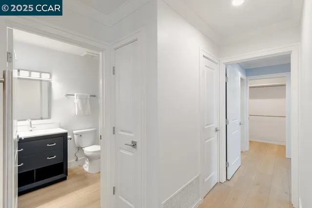 a bathroom with a granite countertop sink a toilet and shower