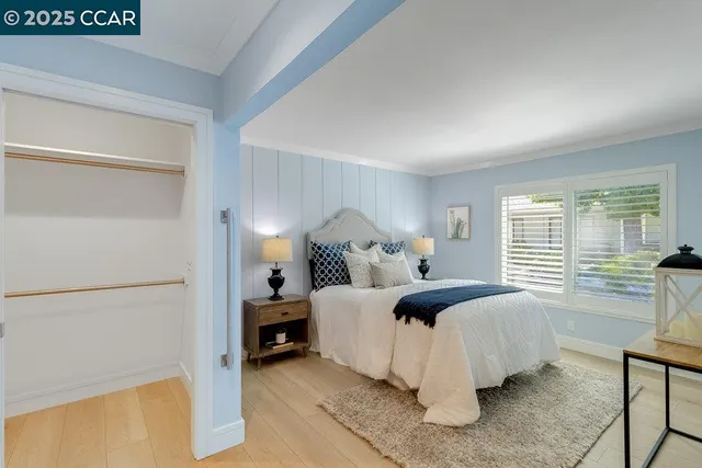 a bed room with a bed and a chair