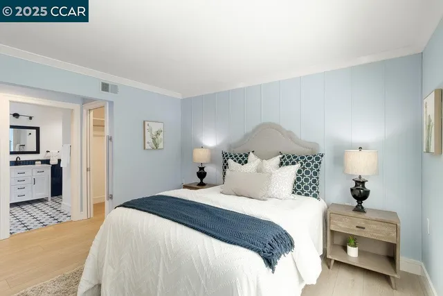 a bedroom with a bed and lamp