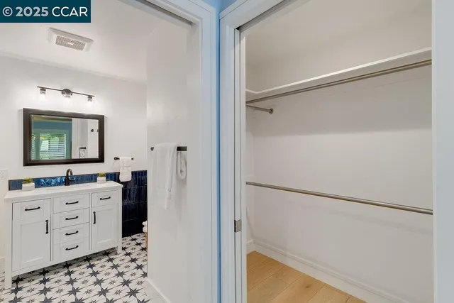 a kitchen with a refrigerator and a stove top oven
