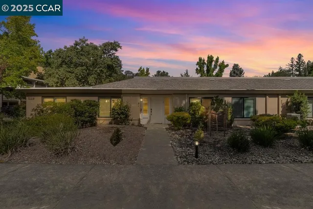 a view of swimming pool with outdoor seating and plants