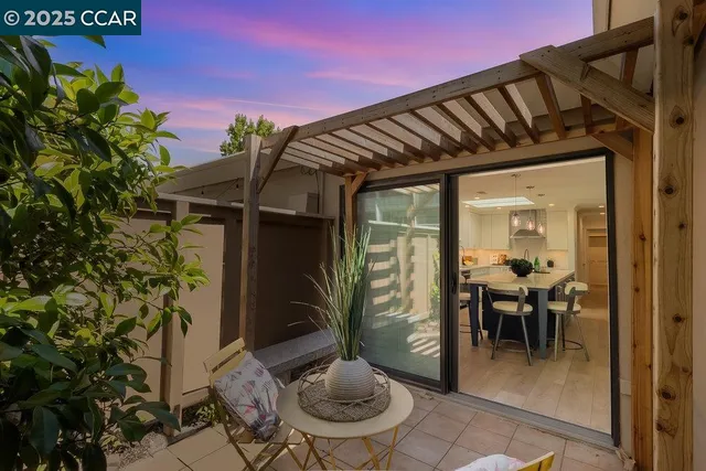 a view of a porch with chairs and potted plants