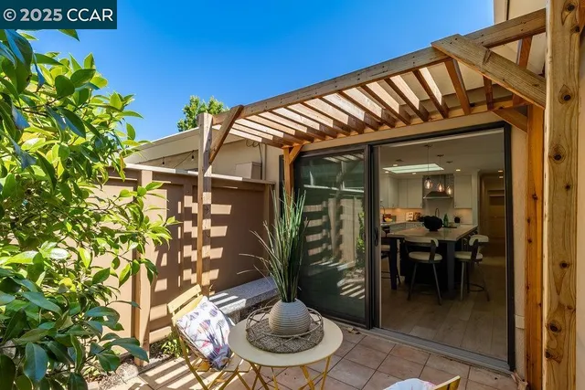 a backyard of a house with table and chairs