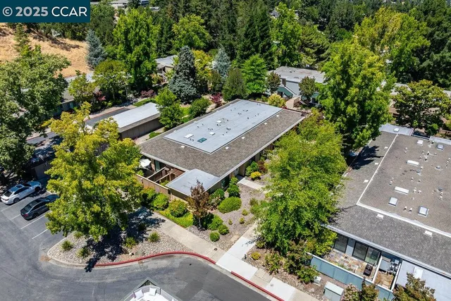 an aerial view of a house with a yard and garden