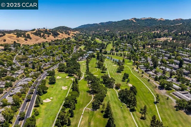 an aerial view of a house with a yard and trees