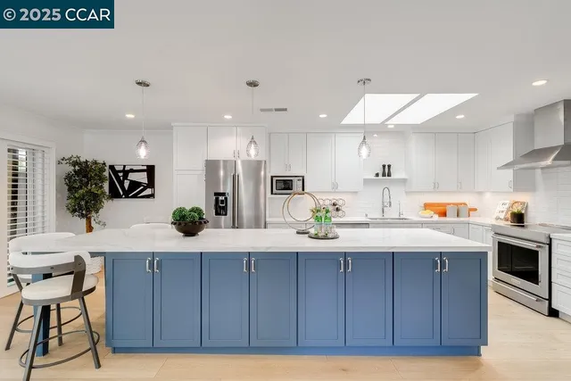 a kitchen with kitchen island granite countertop wooden cabinets dining table and chairs