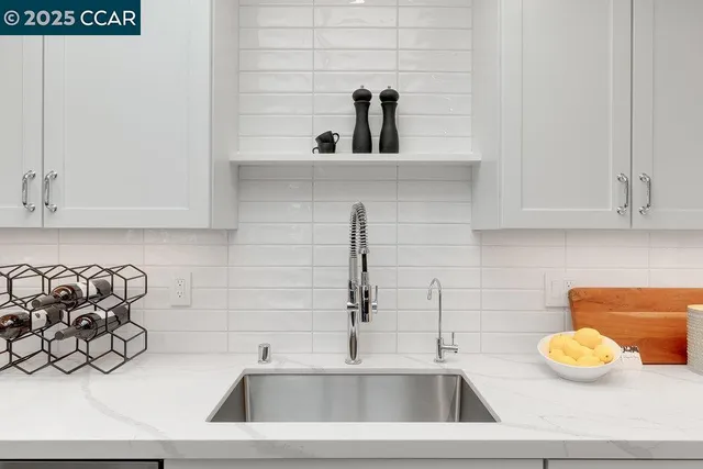 a kitchen with a sink and white cabinets