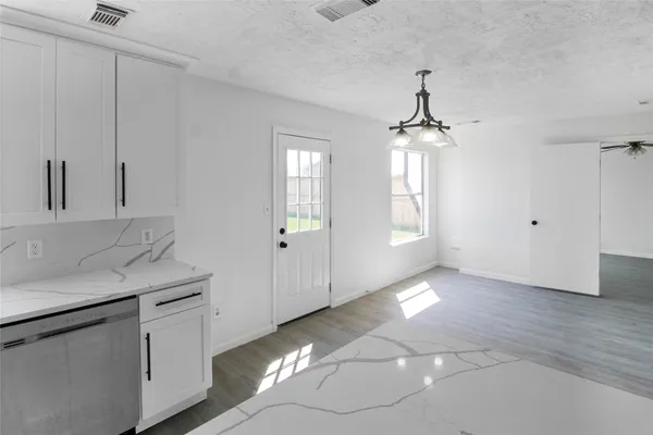 a hallway with a sink and chandelier