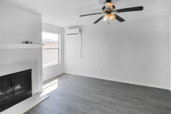 a view of a room with wooden floors and fireplace