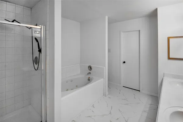 a bathroom with a bathtub and a shower