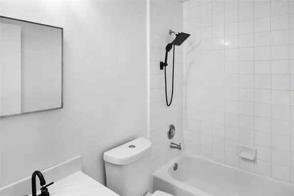 a bathroom with a toilet and a tub