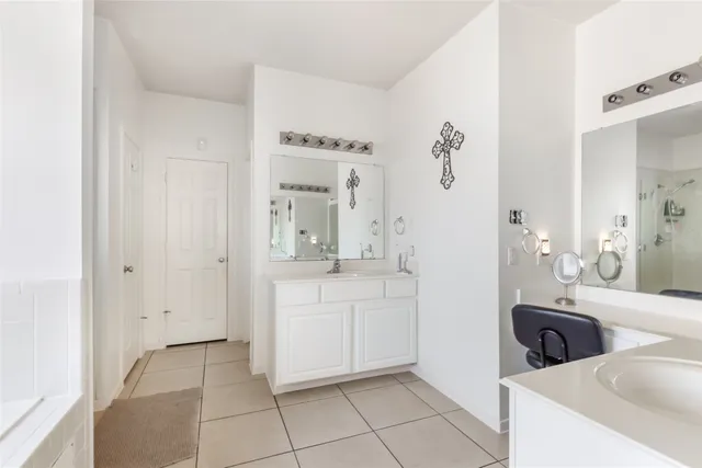a spacious bathroom with a mirror a sink and a mirror