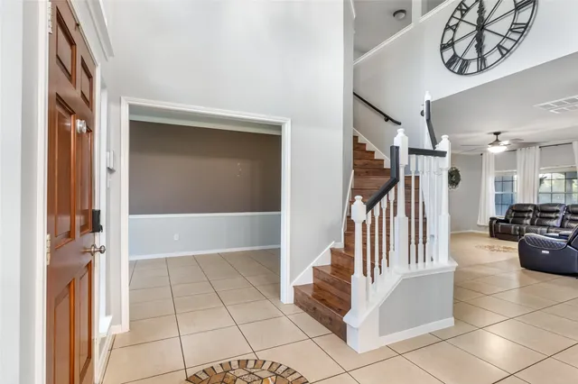 a view of a hallway with entryway and chandelier