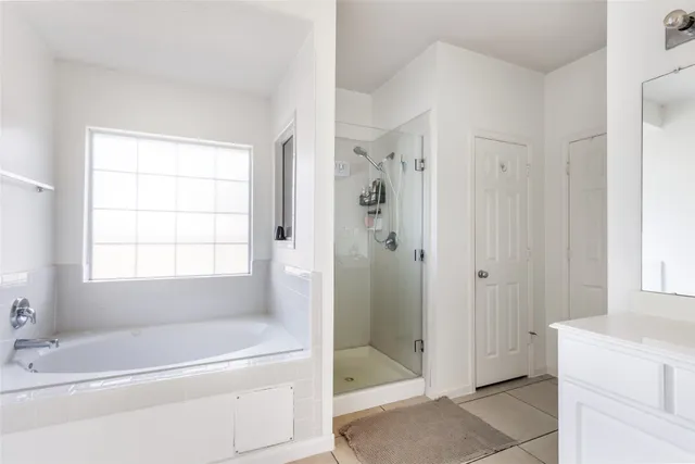 a bath room with a bath tub and a shower