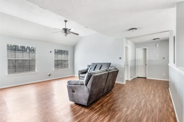 a living room with furniture and wooden floor