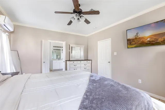 a spacious bedroom with a bed and a chandelier