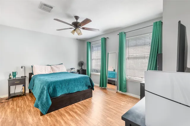 a bedroom with a bed and a chandelier