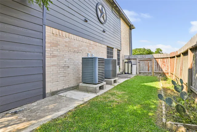 a view of house with backyard and a garden