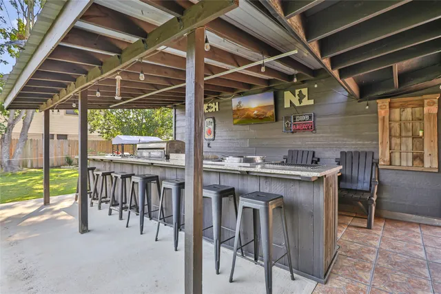 a kitchen view with table chairs and wooden floor