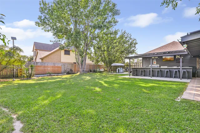 a view of a big yard with large trees and a big yard